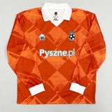 2024/25 Pyszne.pl Cult Kits football jersey in orange with diamond pattern, featuring logo and collar, available in multiple sizes.