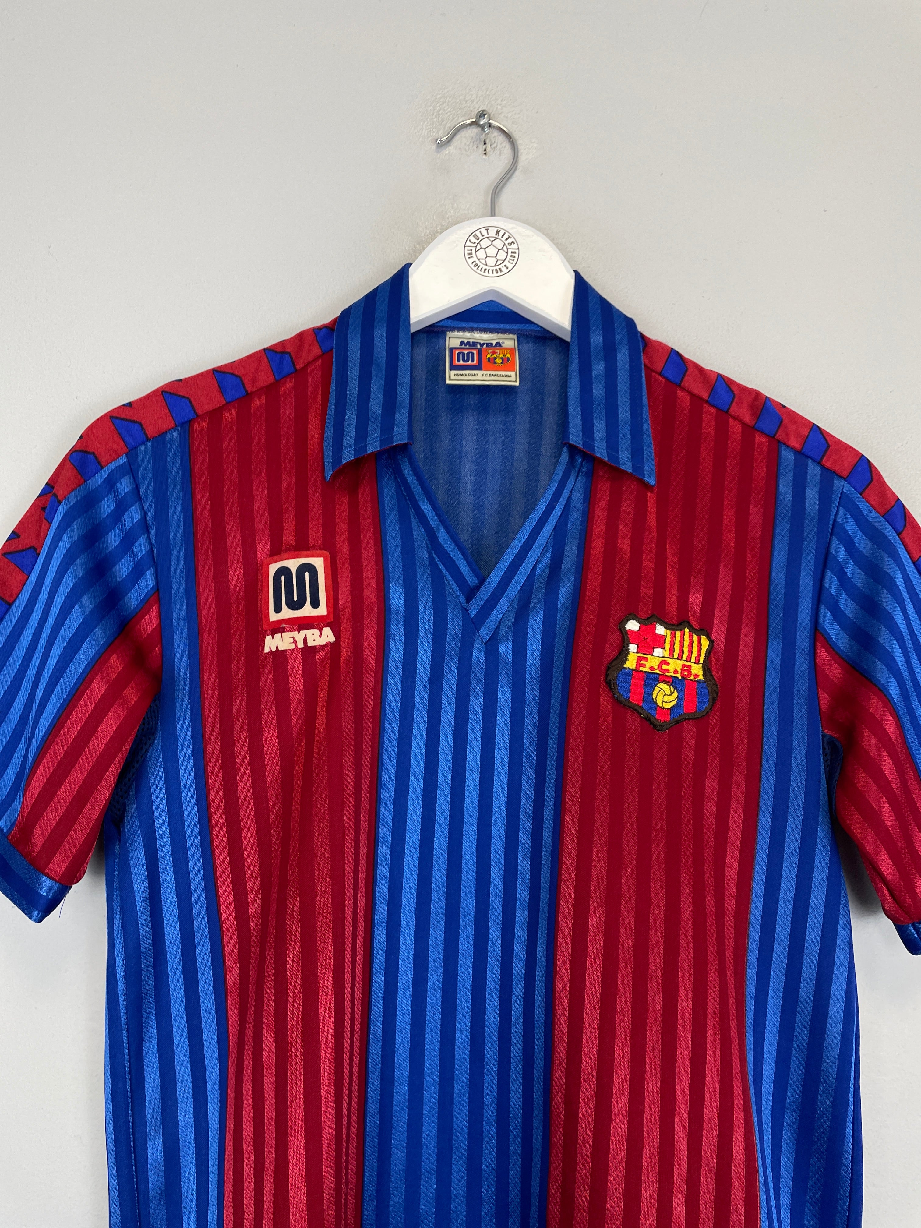 1984/89 Barcelona home shirt by Meyba in excellent condition, featuring blue and red stripes, size small.