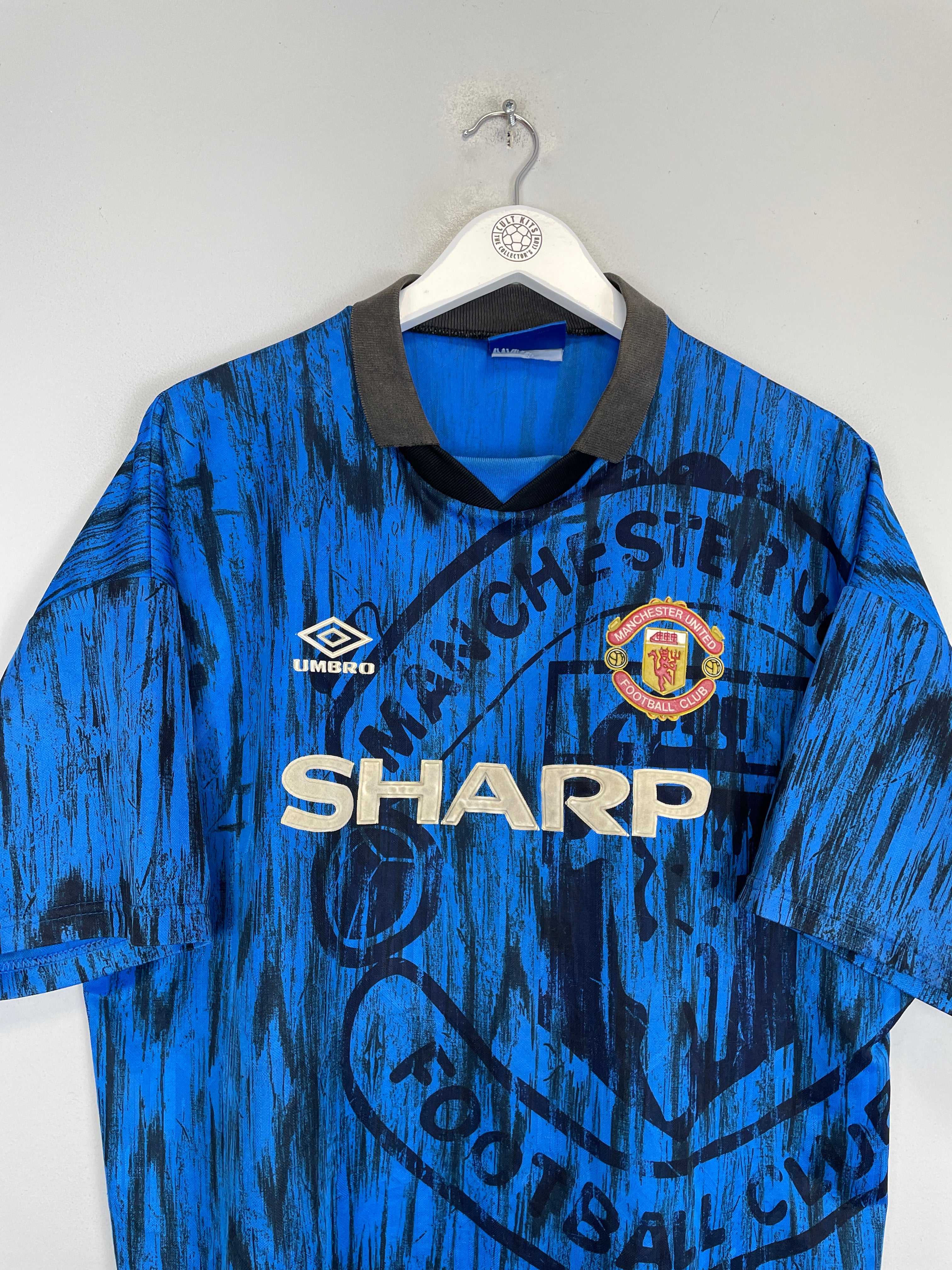 1992/93 Manchester United away shirt in blue, size XL, by Umbro, featuring vibrant colors and vintage design.