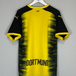 2017/18 Dortmund European home shirt by Puma, size large, featuring black and yellow design with "DORTMUND" printed on the back.