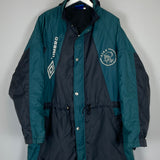 1992/93 Ajax Umbro Bench Coat in XL, teal and black, featuring team logo and manufacturer branding, in very good condition.