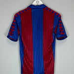 Back view of the 1984/89 Barcelona home shirt by Meyba, featuring blue and red stripes in excellent condition. Size small.