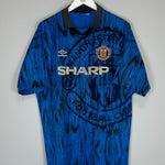 1992/93 Manchester United away shirt in XL, blue with black accents, by Umbro, featuring faded logo and vibrant colors.