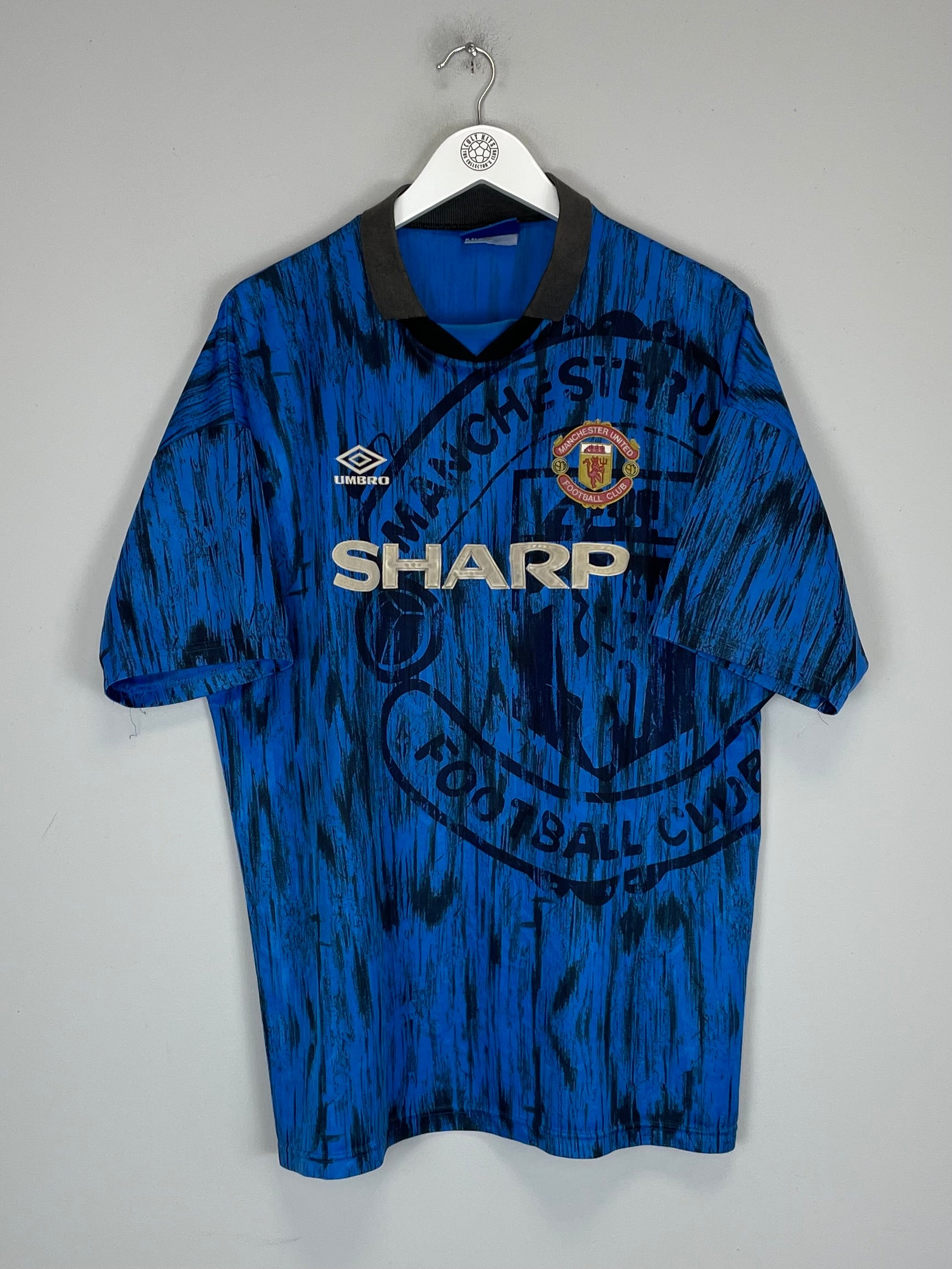 1992/93 Manchester United away shirt in XL, blue with black accents, by Umbro, featuring faded logo and vibrant colors.